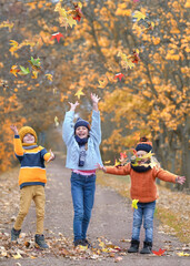 Crisp Fall Fun: Children Throwing Vibrant Leaves