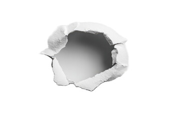 A circular hole punched through white paper.  Crisp edges and torn paper surrounding the void