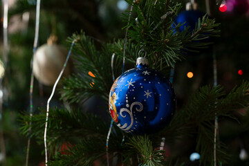 Christmas toys on the branches of the Christmas tree, New Year's Christmas decor, New Year's balls background
