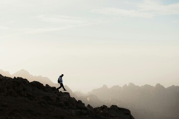 silhouette of a man on the top of the mountain