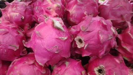 Vibrant Pink Dragon Fruit Pile Fresh Exotic Fruit Background. perfect for food and grocery marketing.