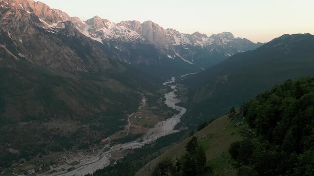 Drone rising over Valbone National Park valley in Albania at sunset