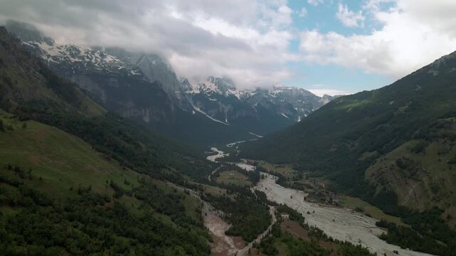 Aerial view of Valbone National Park valley, Albania. Vast landscape of a big river floating between high mountains