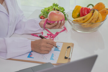 A female lab technician examines broccoli for scientific research in microbiology, biotechnology,...