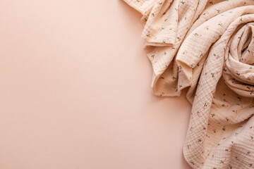 Soft muslin fabric with tiny floral print gently arranged on a pastel pink background. Cozy,...