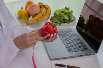 A female lab technician examines broccoli for scientific research in microbiology, biotechnology, and nutrition to advance health.