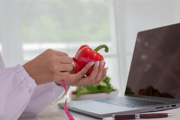 A female lab technician examines broccoli for scientific research in microbiology, biotechnology, and nutrition to advance health.
