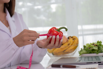 A female lab technician examines broccoli for scientific research in microbiology, biotechnology, and nutrition to advance health.