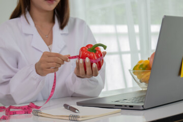 A female lab technician examines broccoli for scientific research in microbiology, biotechnology, and nutrition to advance health.