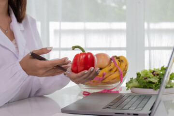 A female lab technician examines broccoli for scientific research in microbiology, biotechnology, and nutrition to advance health.