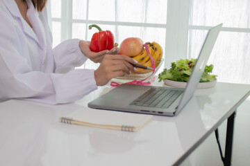 A female lab technician examines broccoli for scientific research in microbiology, biotechnology, and nutrition to advance health.