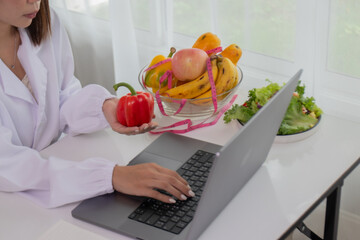A female lab technician examines broccoli for scientific research in microbiology, biotechnology, and nutrition to advance health.