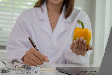 A female lab technician examines broccoli for scientific research in microbiology, biotechnology, and nutrition to advance health.