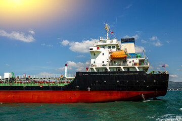 Naklejka premium Oil tanker fleet used for transportation oil in blue sea. Transport for petroleum products, gas and oil under sanctions. Industrial landscape of petroleum logistics