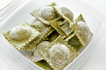 A Close-Up View of Freshly Made Green Ravioli Stuffed with Flavorful Ingredients and Topped with a...