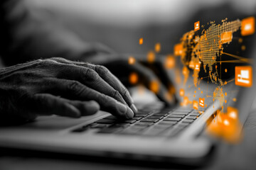 Hand typing on a laptop with digital data and world map projections in the background