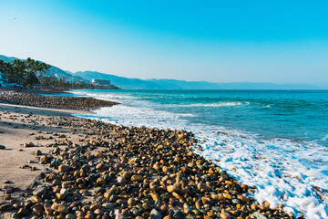 Beautiful beach with stones on bright sunny day in Puerto Vallarta Mexico