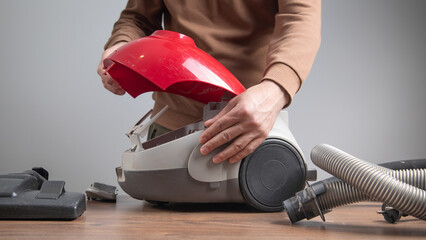 Caucasian master repairing vacuum cleaner. Vacuum cleaner repairing