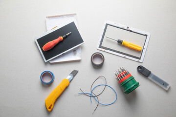 Various tools and broken tablet. Tablet repair