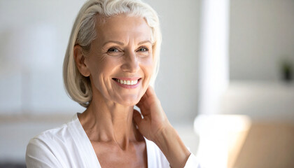 Radiant Senior Woman: A serene portrait of a mature woman with silvery hair and a gentle smile, radiating confidence and a warm, welcoming presence.