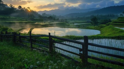 farm and rice terraces with sunrise mist over blue mountains, pond glistening near wooden fence 
