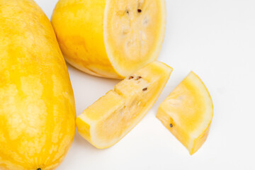 Yellow Watermelon Cut into Pieces on White Background