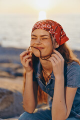 lifestyle woman in modern boho-western denim street style smiling outdoors at sunset with film...