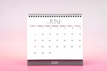 Desktop monthly calendar for June 2026 on pink color background.