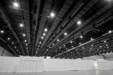 HVAC Duct Cleaning, Ventilation pipes in silver insulation material hanging from the ceiling inside new building warehouse.