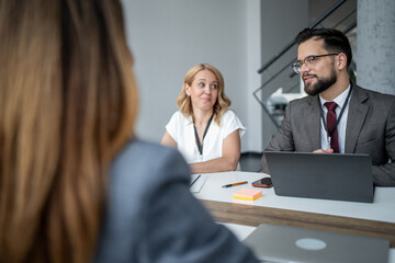 Recruiters listening to applicant during job interview in office