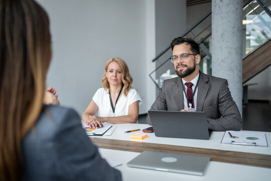 Recruiters interviewing job applicant in modern office meeting room