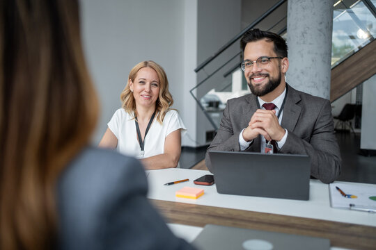 Recruiters smiling and listening to candidate during job interview