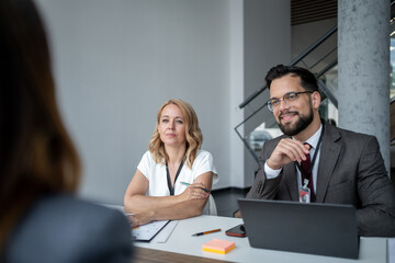 Interviewers listening to applicant during job interview