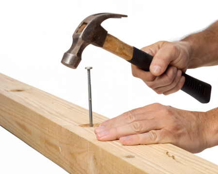 A close-up of a hand hammering a nail into a wooden plank. The hammer is metallic with a wooden handle. The background is transparent.