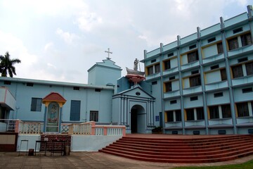 residential and church courtyard entrance of historical bandel church or basilica of the holy rosary, bandel