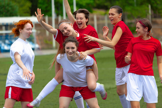 Women football team celebrates their win on the field. Concept of joy in girls sports, celebration and shared success, emotional high points in soccer matches.
