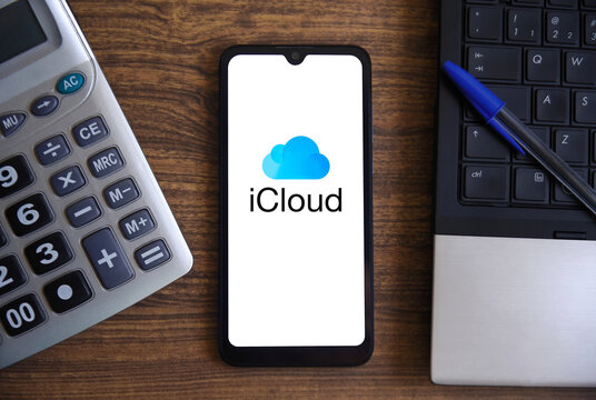 The iCloud logo, Apple's cloud service, is displayed on a smartphone screen on a table with objects. Technology and computing concepts. Rio de Janeiro, Brazil: July 25, 2025.