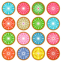 A colorful collection of round gingerbread cookies decorated with intricate white snowflake icing designs.