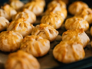 The process of making homemade cakes. A close-up shot of a lot of pies with different fillings on the kitchen table in a home kitchen.