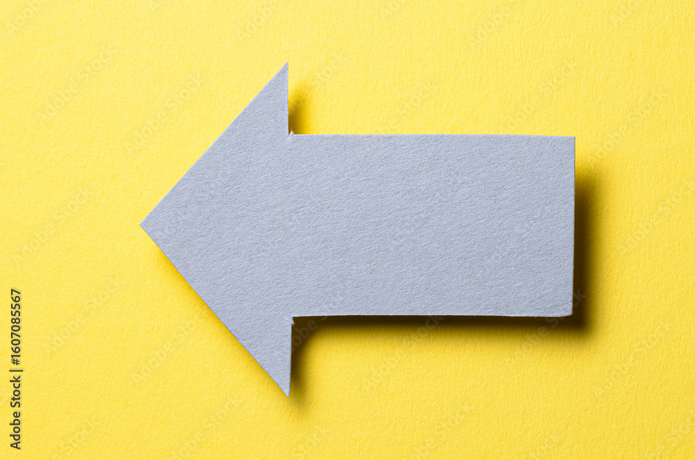 Fototapete gray cut out blank paper cardboard arrow direction sign with copy space for text on yellow backgroun