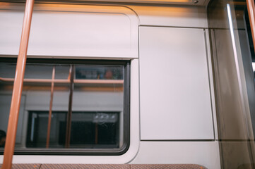 An advertising poster on the wall of a train car in the subway. Free space.