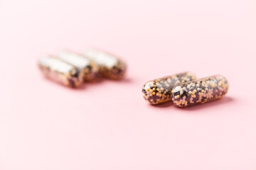 Iron capsules on bright background. Soft focus. Close up. Copy space.	