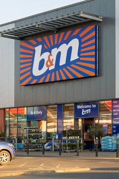 AYR, UK &ndash; April 7, 2025: B&M discount store signage above shop entrance in Heathfield Retail Park with blue, orange, and white design