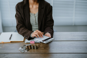 Unrecognizable woman holds receipts pencil uses laptop plans budget manages expenses calculates...