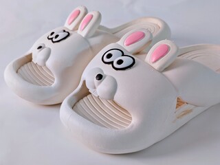 Whimsical Bunny Slippers: A Pair of Cartoonish Comfort on White Background