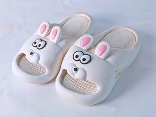 Whimsical Bunny Slippers: A Pair of Cartoonish Comfort on White Background