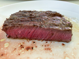 Juicy Medium-Rare Steak Served on White Plate