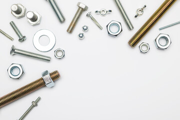 Top view mix of metal fasteners on white background.