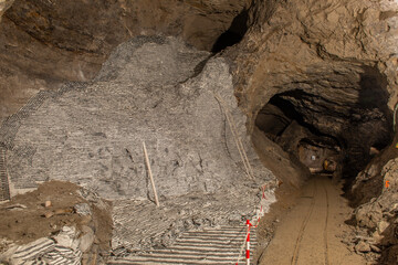 Interior of the Dossena mine with colored stones for an artistic installation.