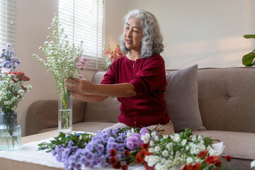 Elderly Woman Arranging Fresh Flowers at Home